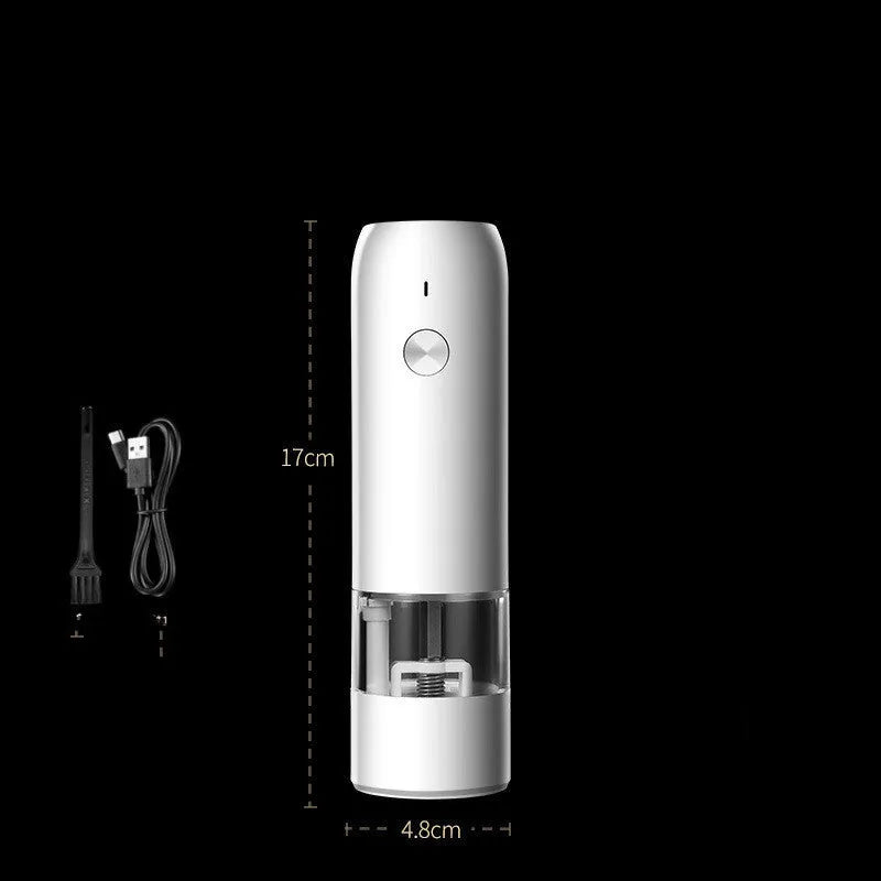 Black and white electric salt and pepper grinder set with USB charging cable on a kitchen worktop.