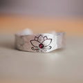 Silver alloy electroplated lotus ring on a light background, glossy finish, minimalist design