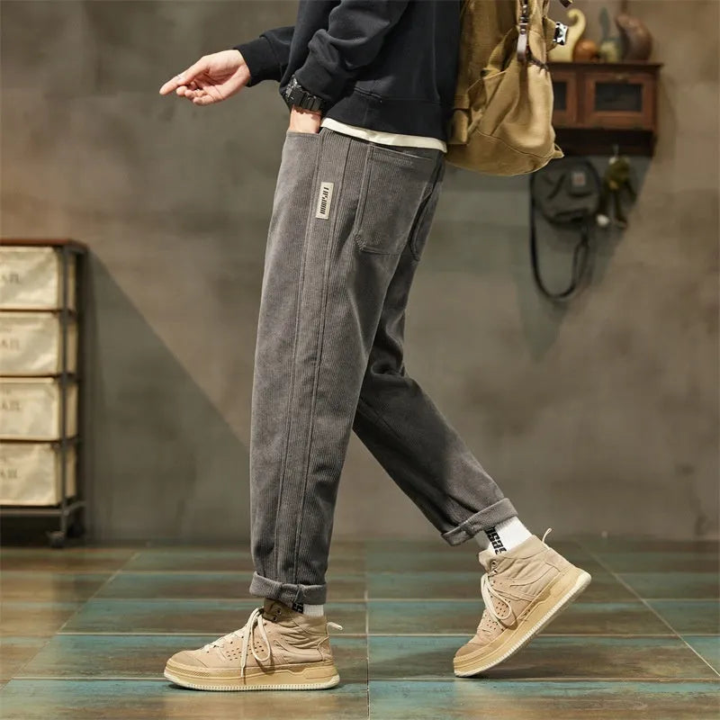 Corduroy men's casual trousers in street fashion style with straight leg opening and tapered cut