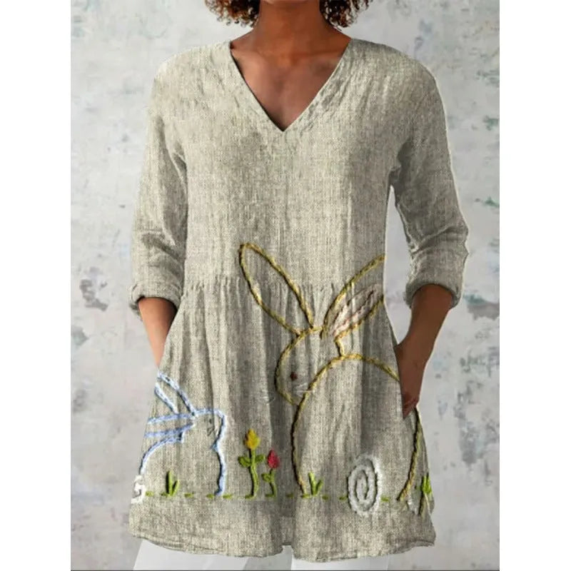 Women's loose-fitting dress with a blue wave print pattern, wide waist, and three-quarter length sleeves.