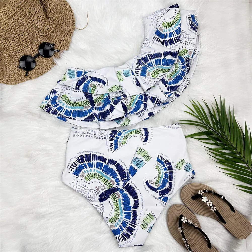 White women's one-shoulder swimsuit with large lotus leaf detail and split design