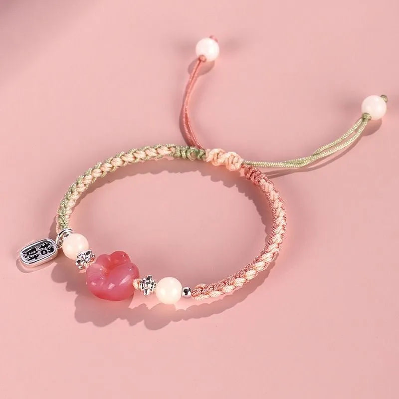 Handmade red cat's paw charm bracelet with pink woven band for couples.