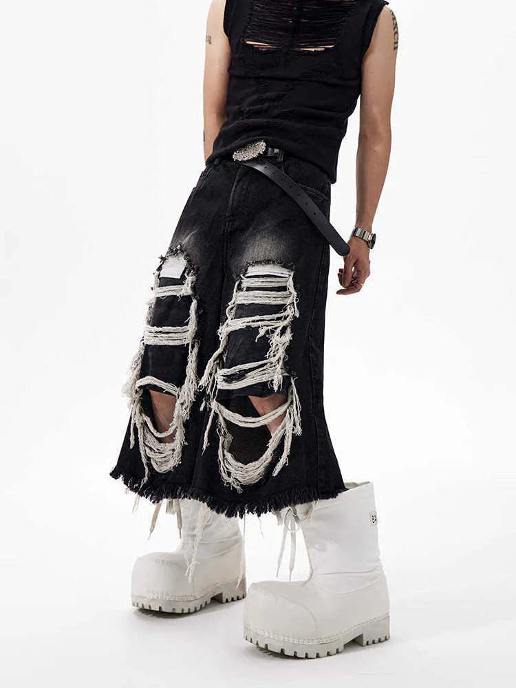 Black women's wide-leg cropped jeans with ripped patchwork details on cotton denim.