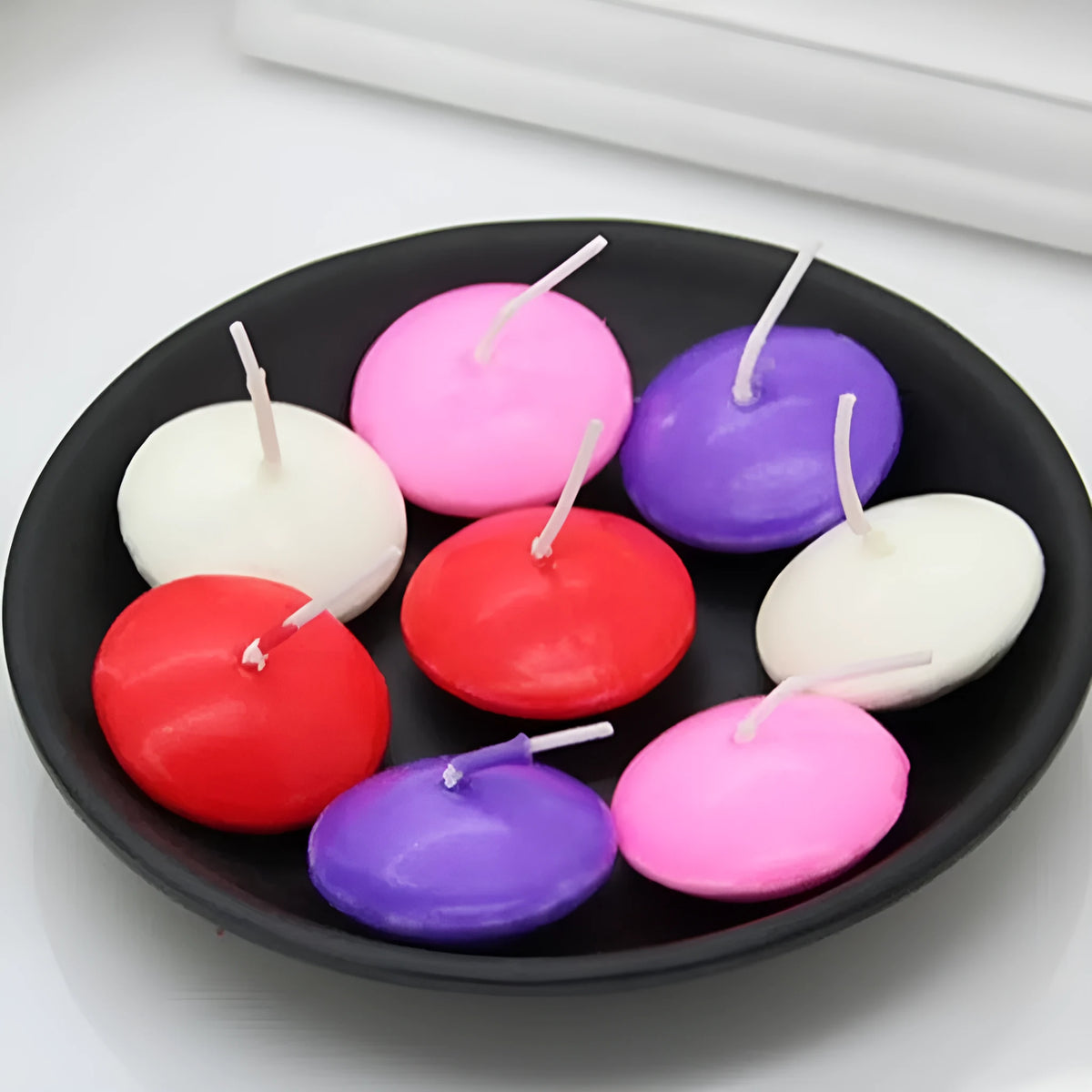 Pack of 10 floating candles in ivory white, red, pink, pure white, and yellow, cylindrical paraffin wax