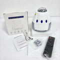 Space capsule shaped USB galaxy projection lamp with remote control on a surface.