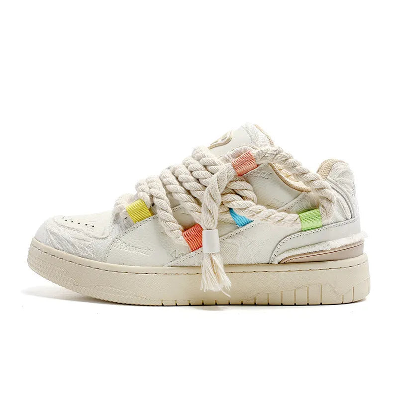 Creamy white retro low-top skateboard shoes with a platform sole and lace-up fastening.