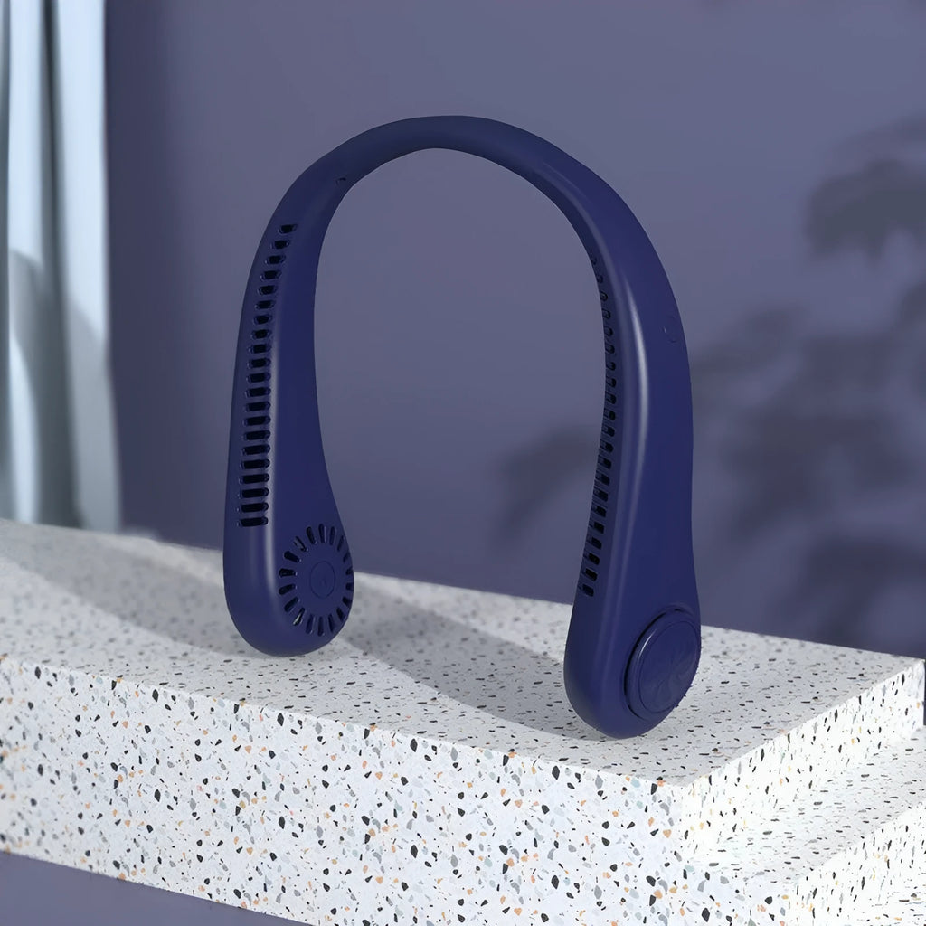 Blue portable bladeless neck fan hanging around a person's neck, showing its compact design.