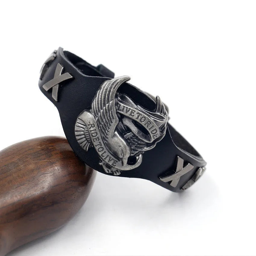 Black leather geometric bracelet with an eagle watch clasp, showing tapered width.