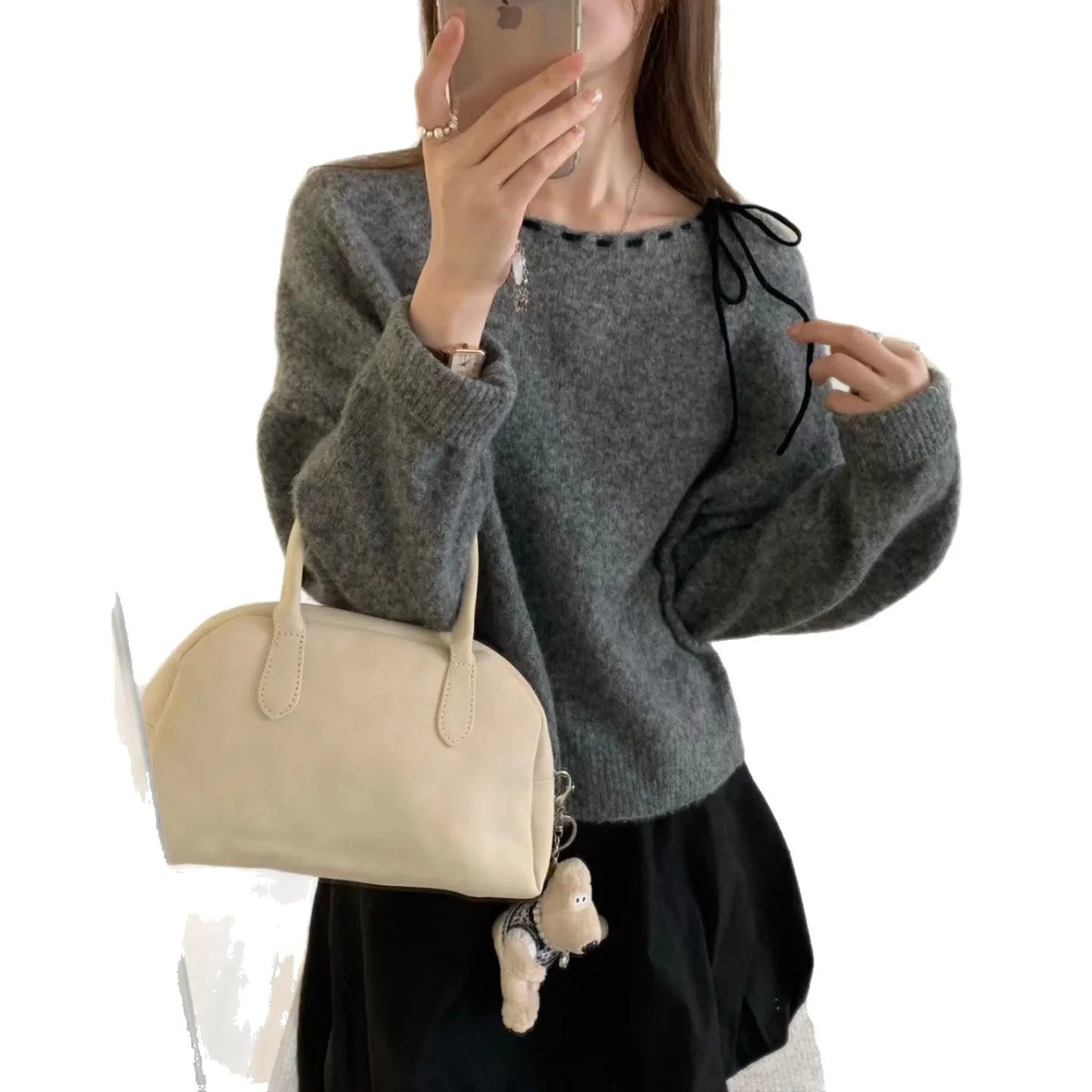 Grey loose-fitting women's knitwear pullover on a hanger.
