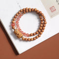 Brown wooden bracelet with 6mm round beads featuring a woven South Red Zachilam double circle design.