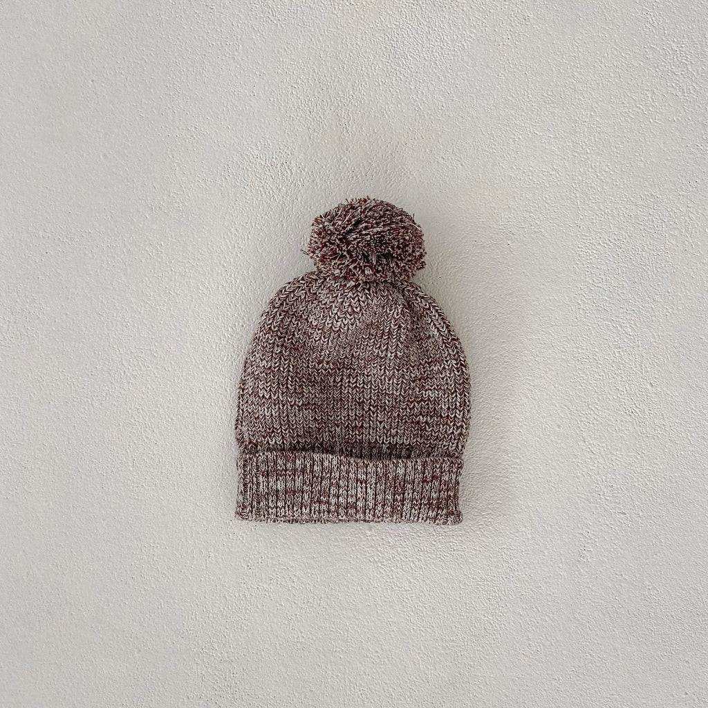 Dark brown knitted baby girl three-piece set with removable fur ball hat, blouse, and shorts