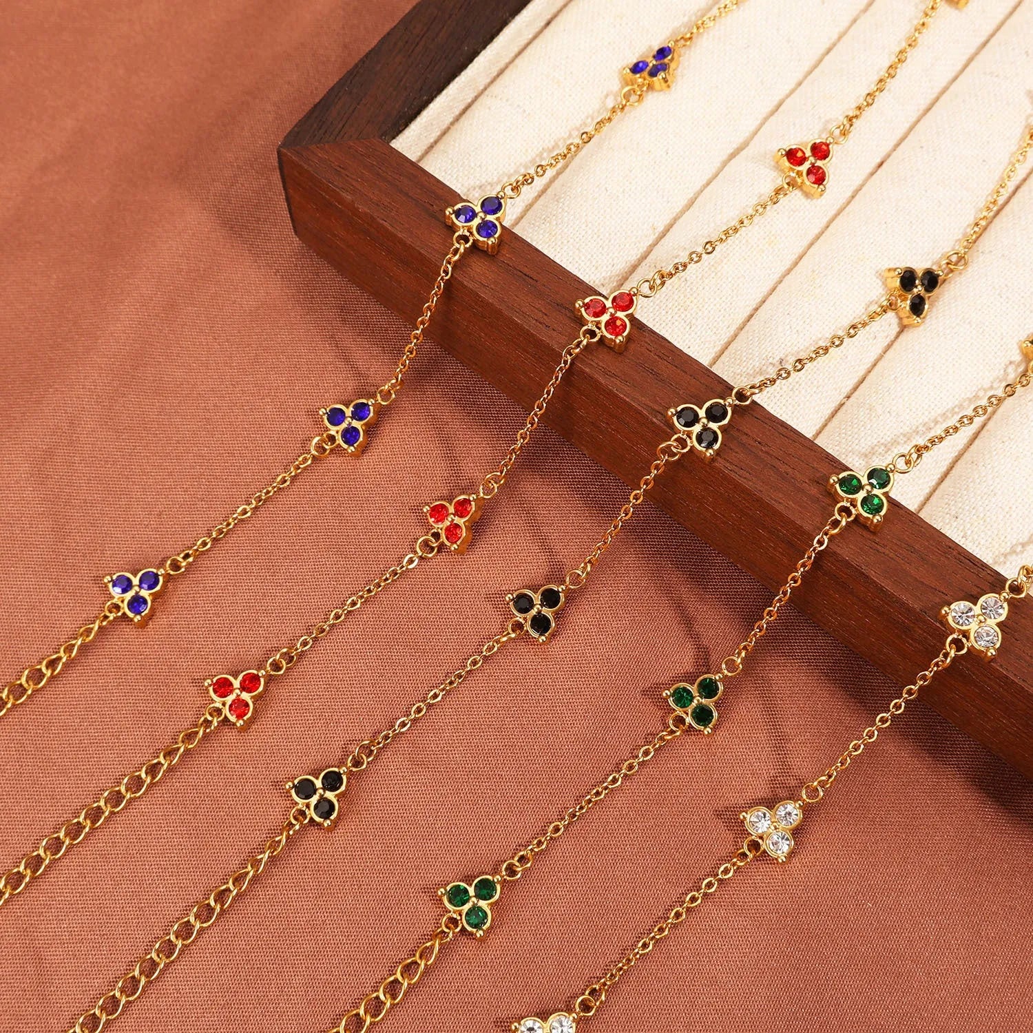 Women's stainless steel geometric bracelet with three diamond triangle design and coloured stone accents