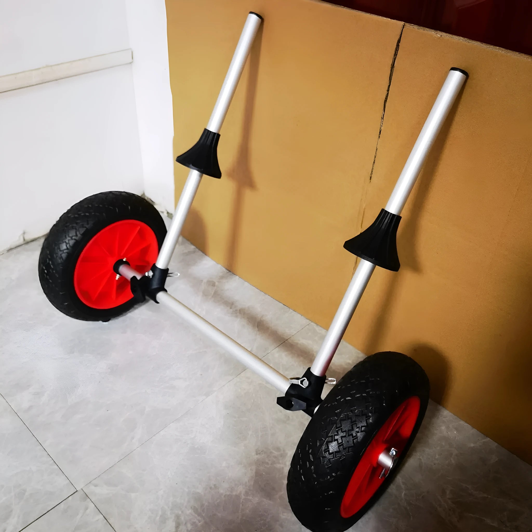 Foldable aluminium kayak beach trailer with upright pole platform and rubber wheels.