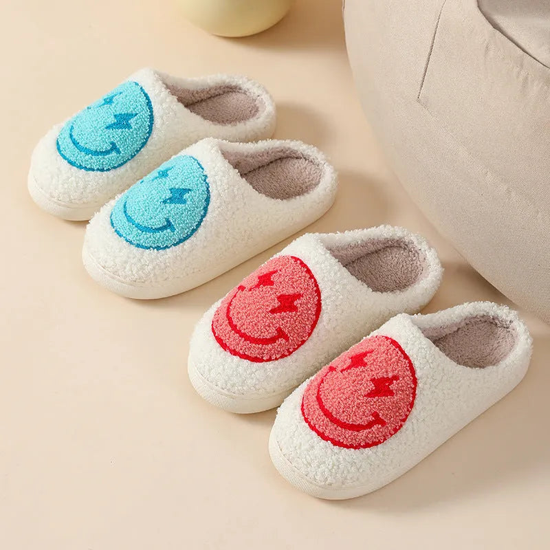 Women's cartoon love style plush slippers in blue smiley colour with round toe and non-slip sole.