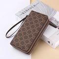 Black retro print long wallet clutch bag with zipper, holding a mobile phone and cards.