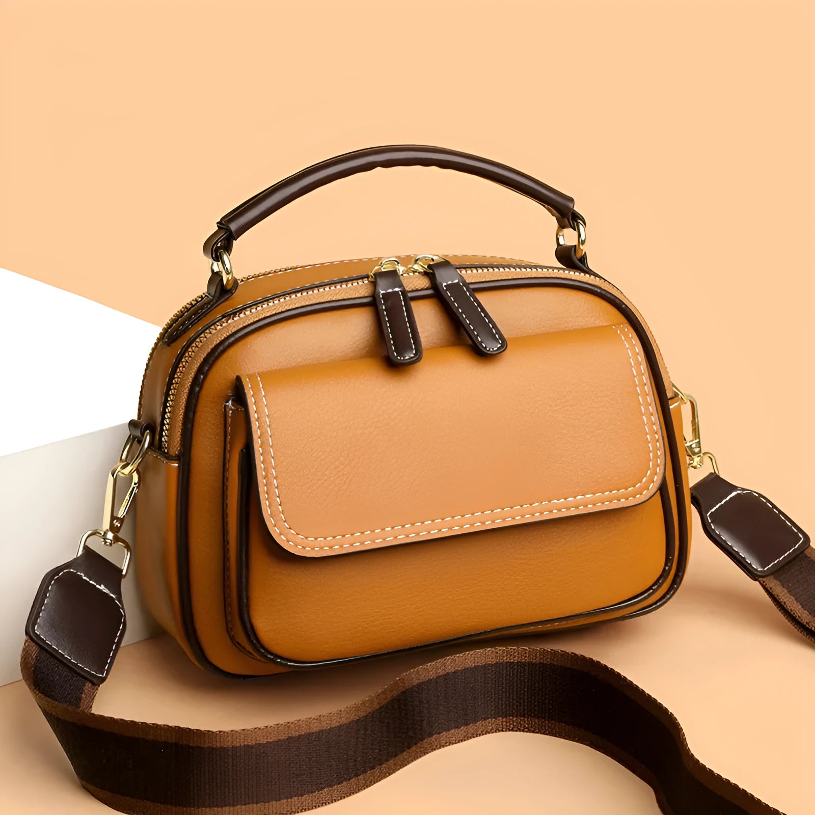 Women's black PU leather cross-body shoulder bag showing horizontal square shape and double straps