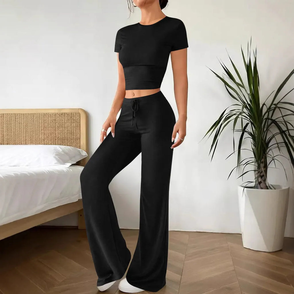 Black high-waist trousers and regular-sleeve T-shirt matching set for women laid flat.