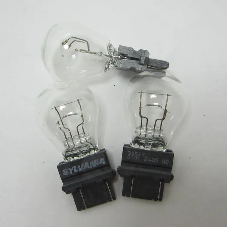 Wagner brake light bulb with yellow glass and dual wire connections for industrial equipment lighting