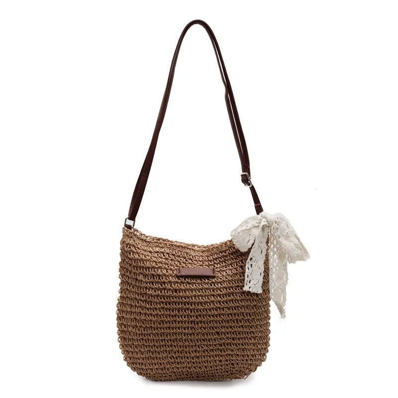 Women's khaki woven straw messenger bag with hollowed pattern and single shoulder strap.