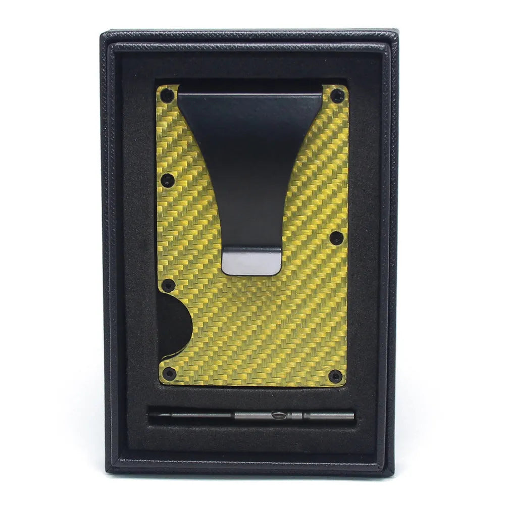 Slim black carbon fibre card holder wallet with geometric design on a desk.