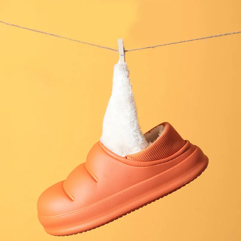 A pair of waterproof EVA garden slippers with a plush lining, shown in a solid colour with a non-slip sole.