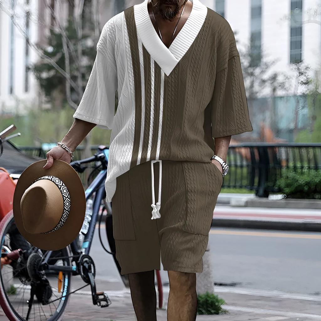 Man wearing a printed drop-shoulder knitted top and matching shorts from a casual summer suit.