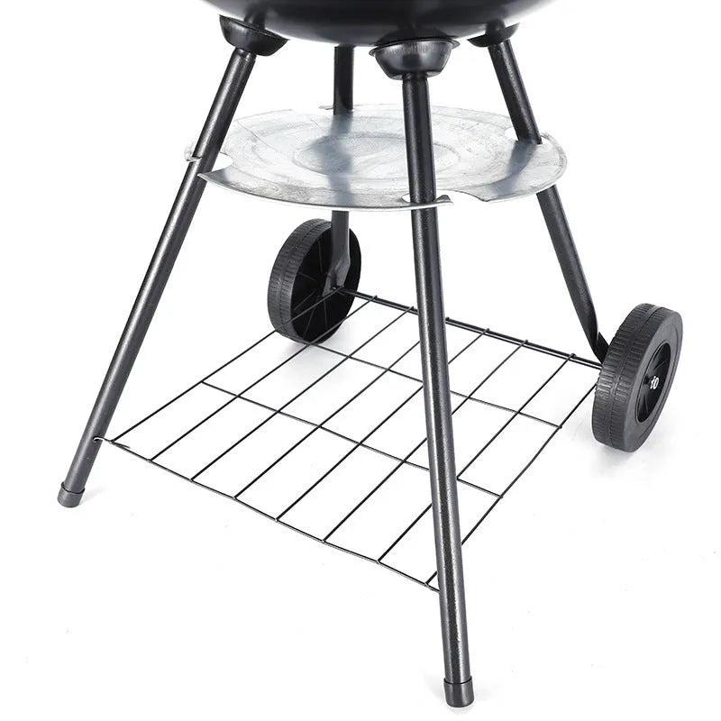 Portable iron barbecue oven with 14-inch apple stove design on a table outdoors.