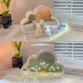 Assembled pink tulip-shaped night lamp with LED light, mirror front, and small photo frame on a desk.