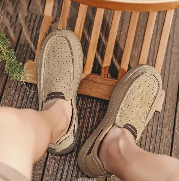 Men's breathable hollow leather slip-on casual shoes in black, side view