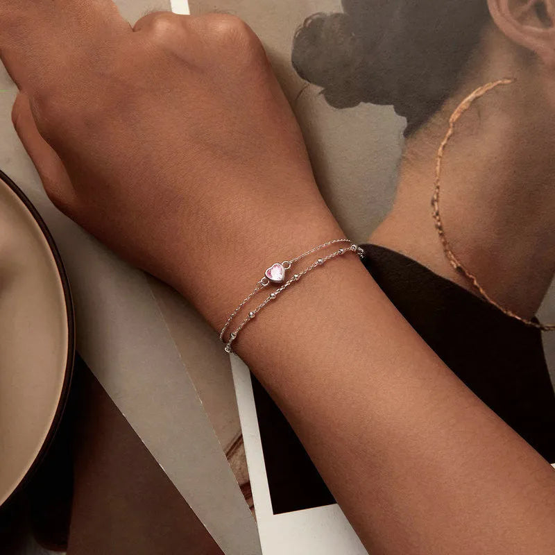 Women's sweet style 925 silver bracelet with small heart-shaped pendant on an adjustable chain.