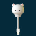USB portable cartoon animal LED night light with remote control on a bedside table.