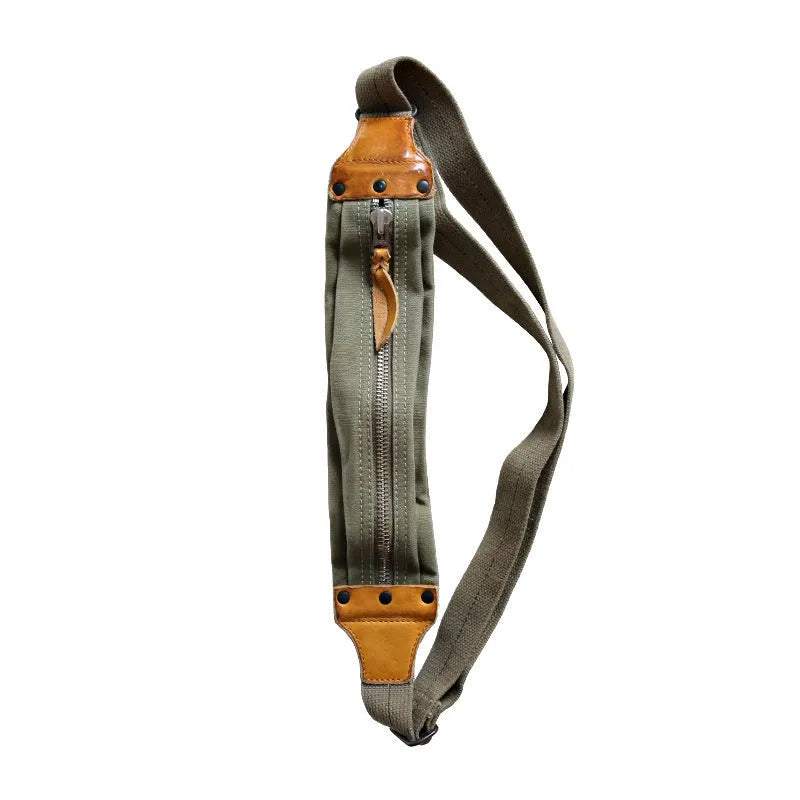 Green military style chest bag with washed canvas exterior and brown Italian leather accents