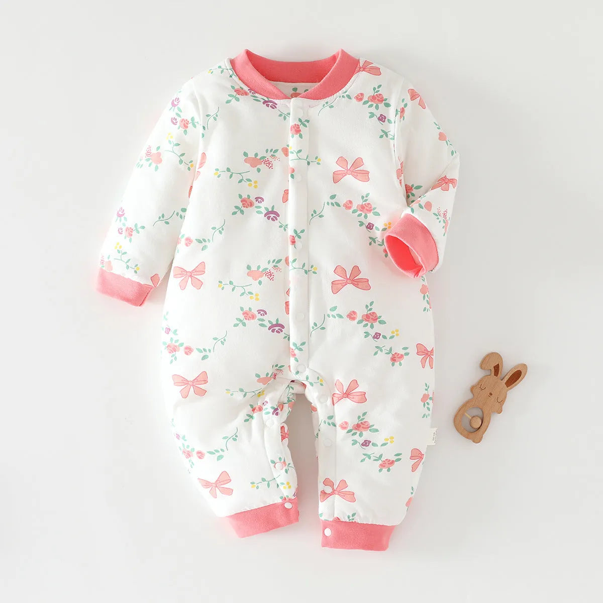 Infant one-piece romper in cotton with closed crotch, long sleeves, and animal-themed colours.