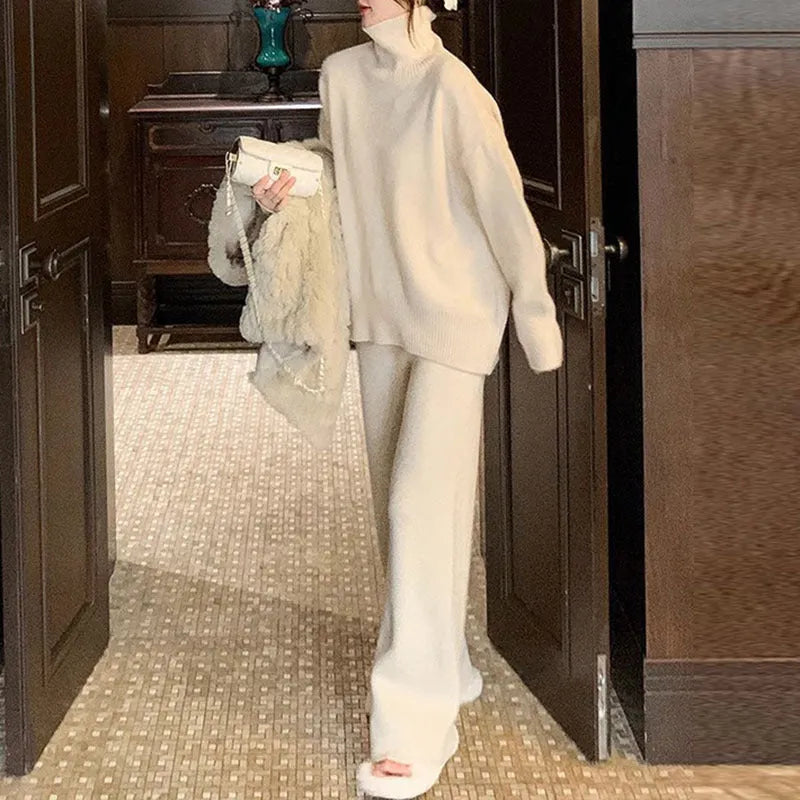 Women's beige acrylic sweater and wide-leg trousers casual two-piece set on a hanger.