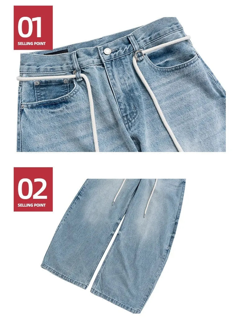 Blue vintage washed straight-leg denim trousers with drawstring belt laid flat