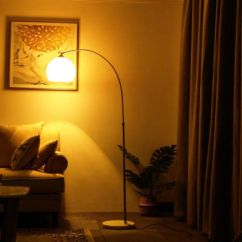 Modern minimalist fishing floor lamp with white acrylic shade on marble base with polished stainless steel pole