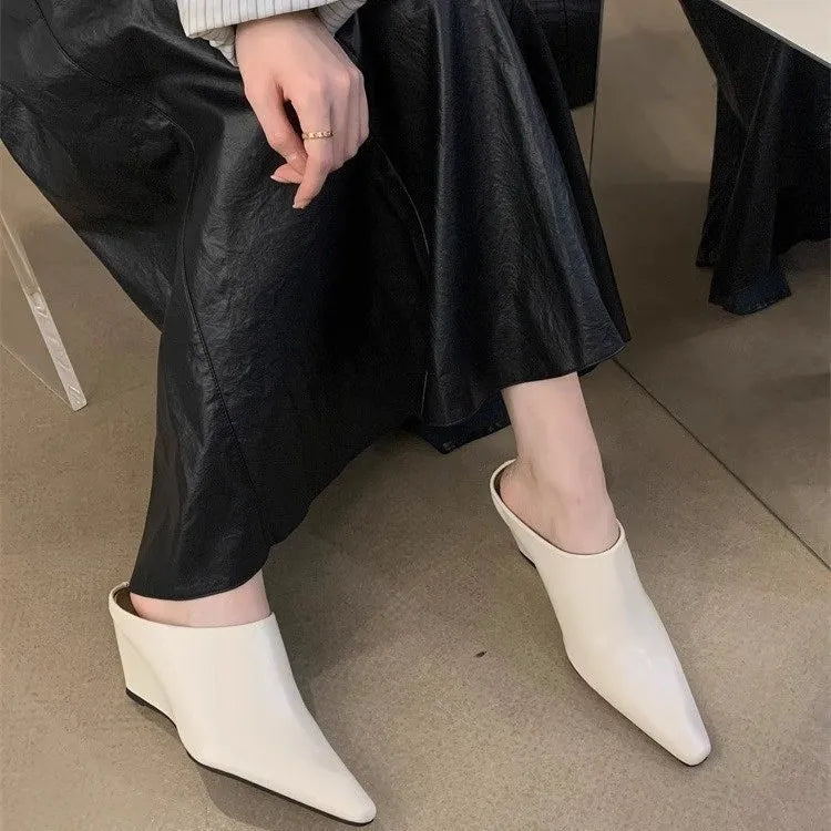 Women's black wind wedge closed toe half slippers made of PU material.