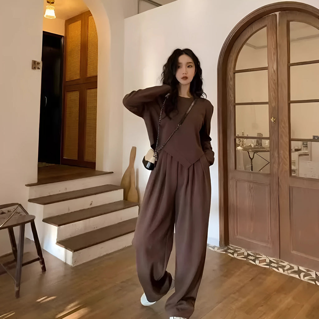 Women's khaki coloured loose-fit casual sports suit with long sleeves and trousers on a hanger.