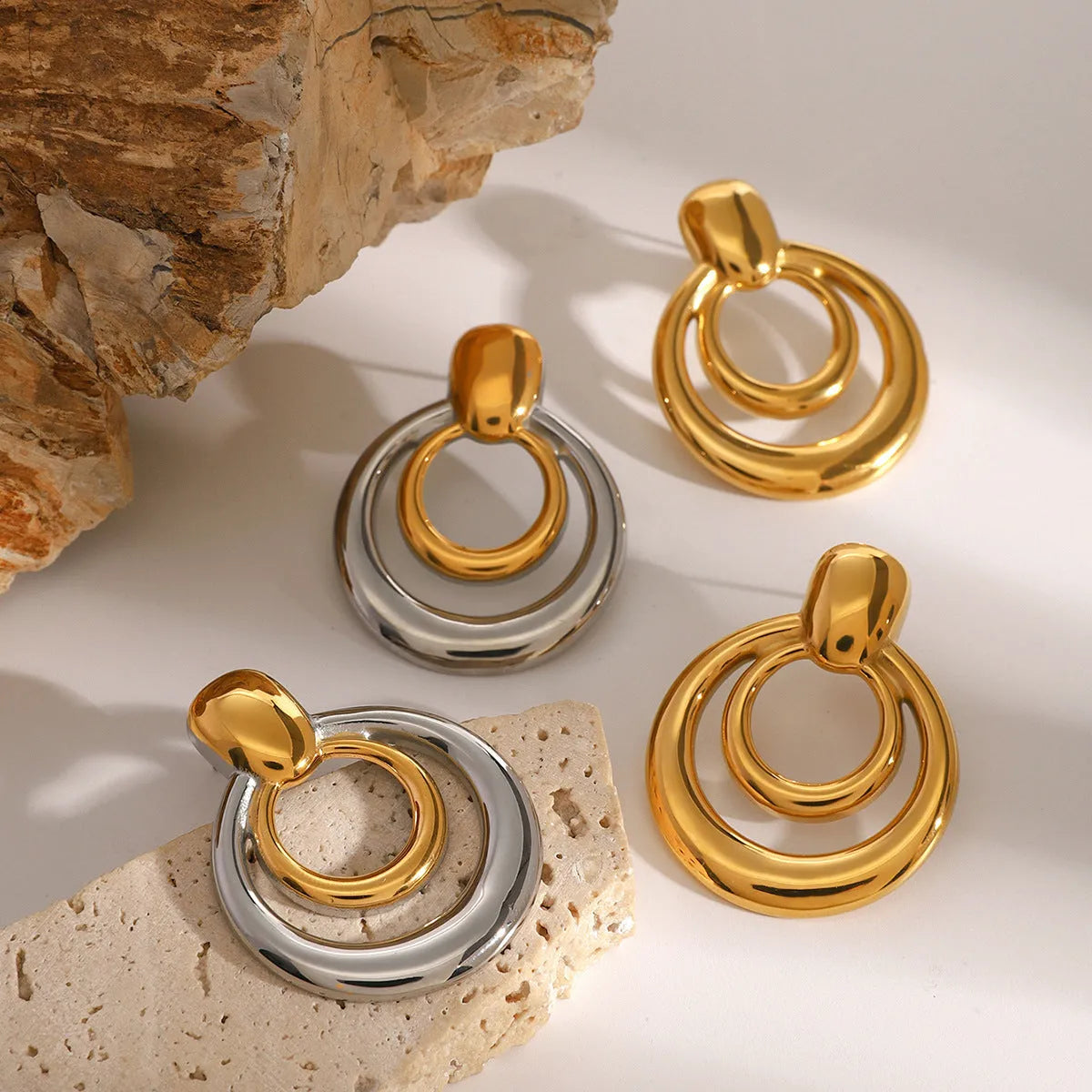 Golden round double layer hollow stud earrings with titanium steel construction and 18k gold plating