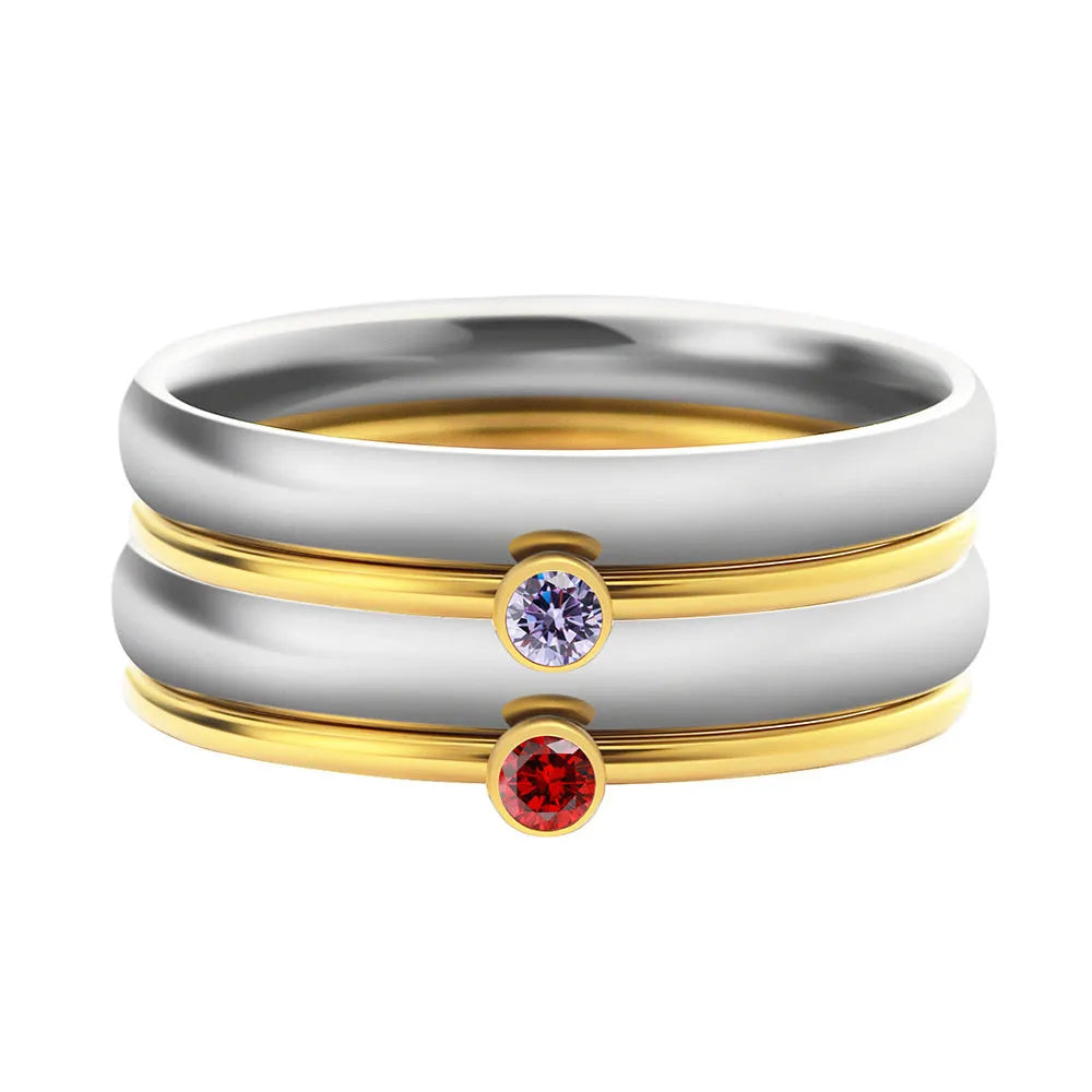 Geometric titanium steel ring with December birthstone colour and engraved gold lettering on band.