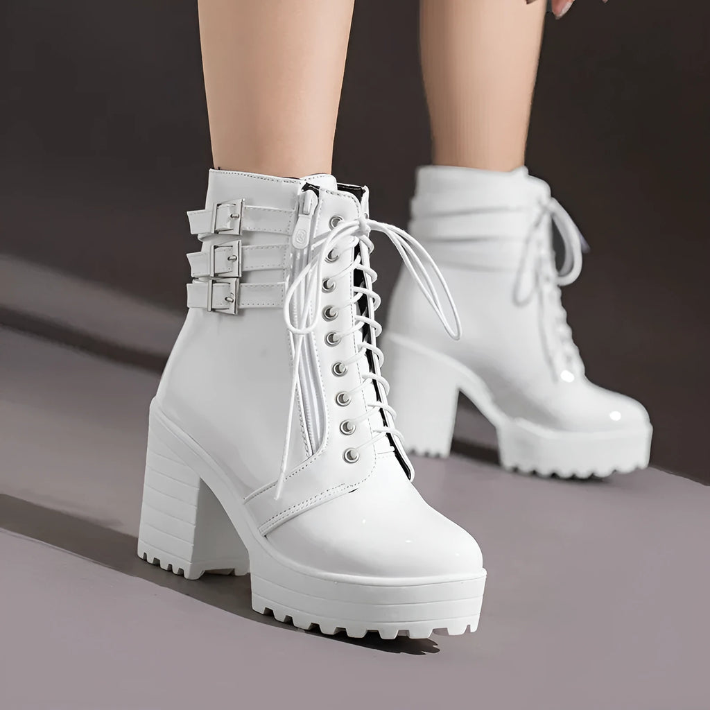 Women's black thick-heel ankle boots with lace-up front and round toe on a rubber sole.