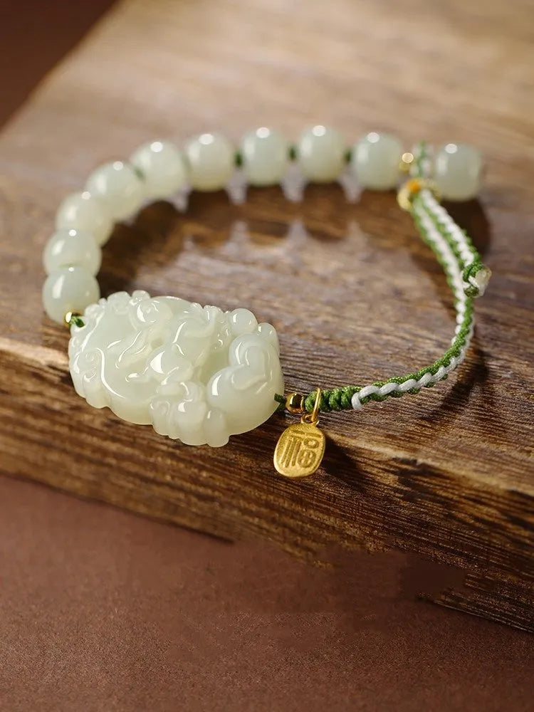 Year of Rabbit red rope bracelet with Hetian jade bead and S925 silver card on a white background.