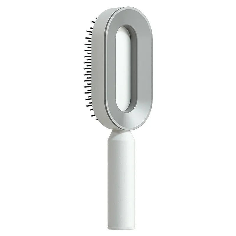 Self-cleaning air cushion hair brush in white, black gold, or black purple with ergonomic handle