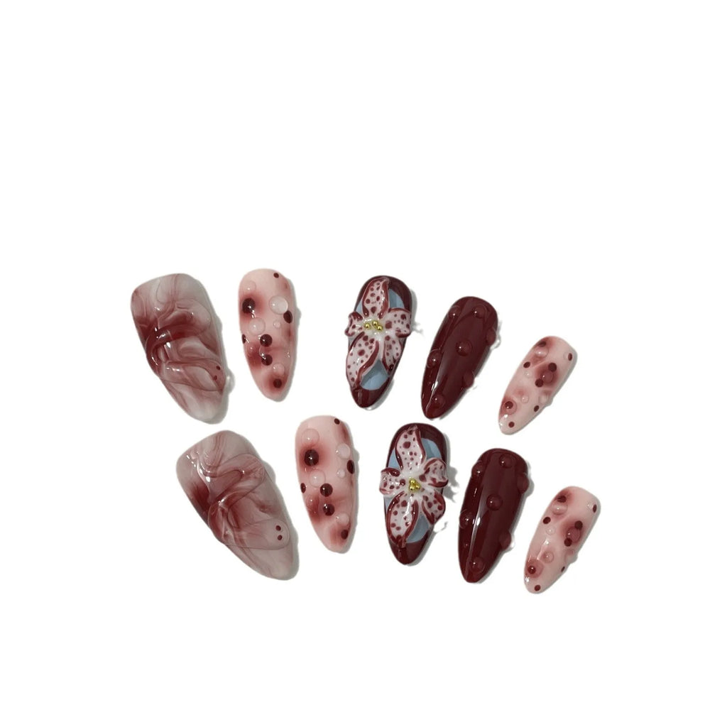 Hand-painted three-dimensional carved almond manicure nails with floral patterns in medium length