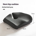 A black memory foam office chair cushion measuring 36 by 40 centimetres on a desk chair.