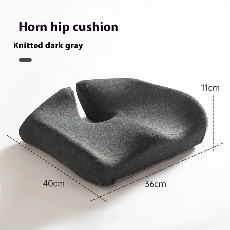 A black memory foam office chair cushion measuring 36 by 40 centimetres on a desk chair.