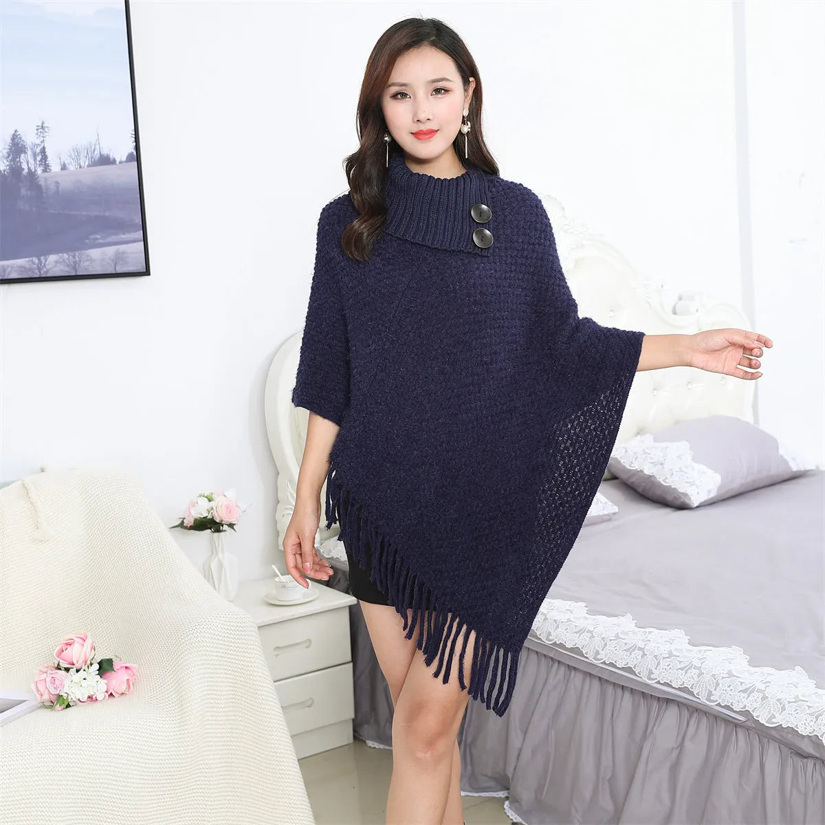 Dotted pattern sleeveless knitted cloak shawl in acrylic fibre, shown in apricot colour.