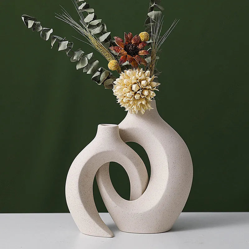 Two European ceramic vases with glazed snuggle colour finish, set on a shelf for creative home decoration