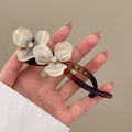Retro flower design bobby pin hair accessory with acrylic petals in blue, beige, or pink.