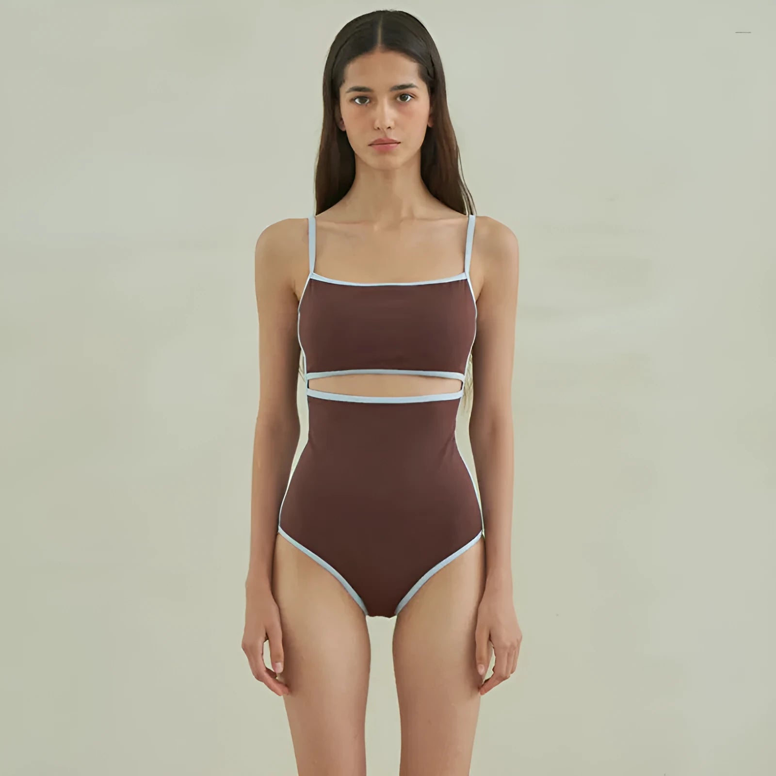 Brown triangle one-piece swimsuit for women on a mannequin, showing front design.